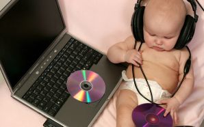 cute baby with laptop and listen music